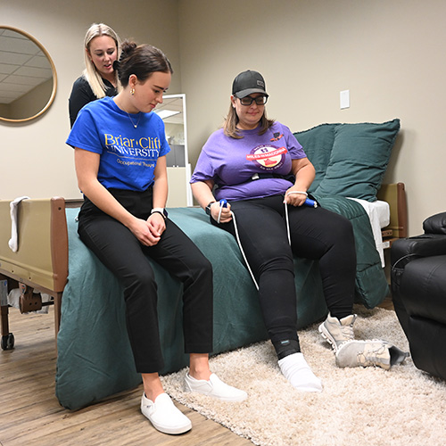 Student and instructor examining forearm muscles. 