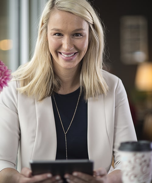 Female business women looking over notes in ipad. 