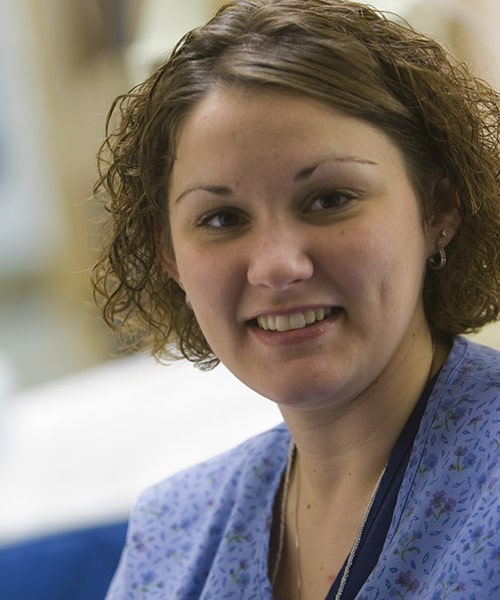 Nursing instructor teaching students how to perform check up