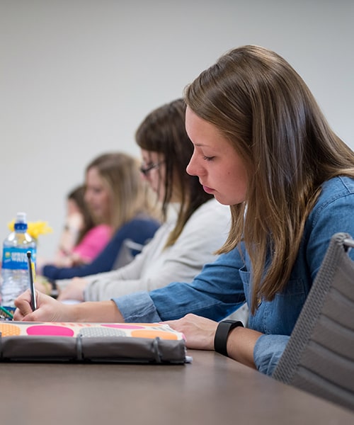 female student working on writing assignment.