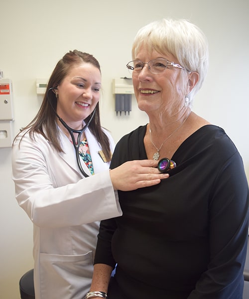 Student nurse checks vitals of patient. 