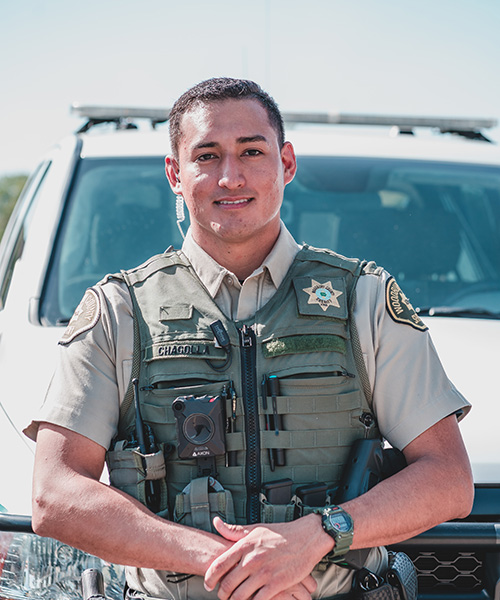 Police officer in front of squad car