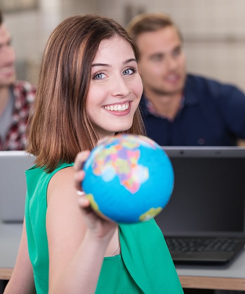 Female student learning about international business in the classroom. 