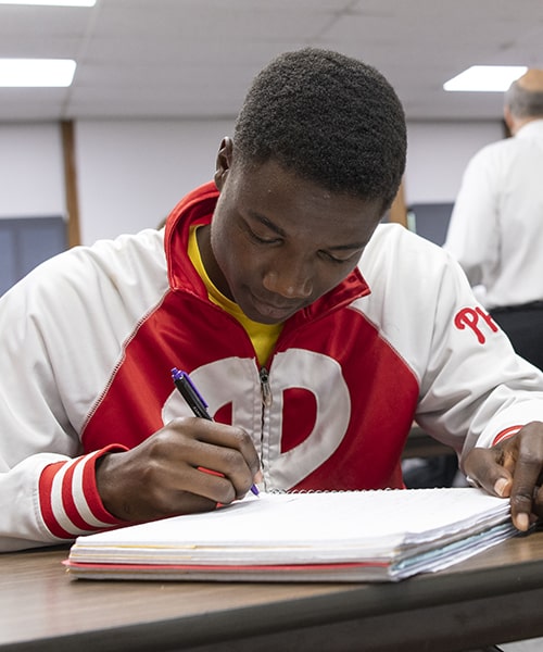 Student taking notes during class