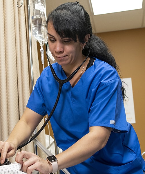 Nursing student checking vitals of patient