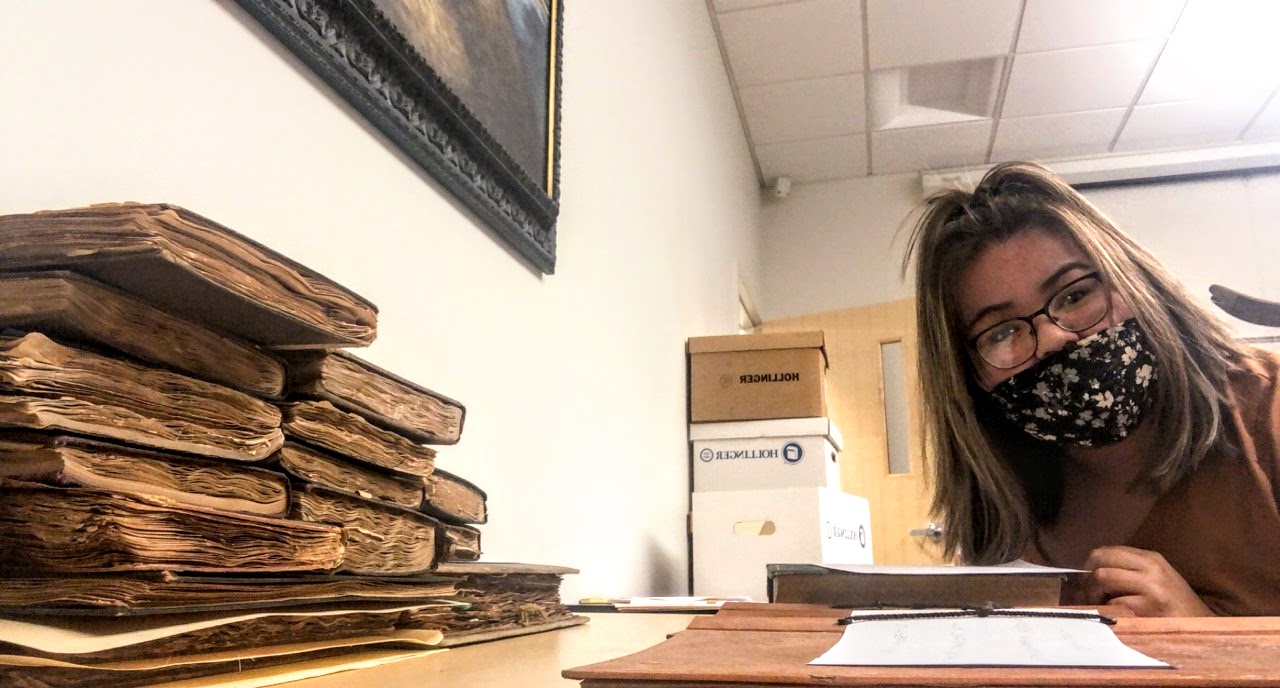 Jakie Ramos looking through Sioux City history scrapbooks